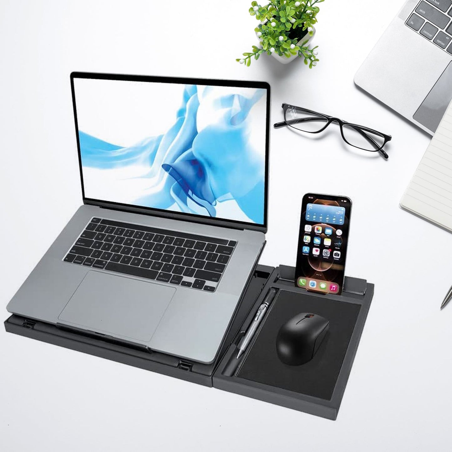 Portable foldable laptop stand with phone holder, compatible with MacBook and tablets.